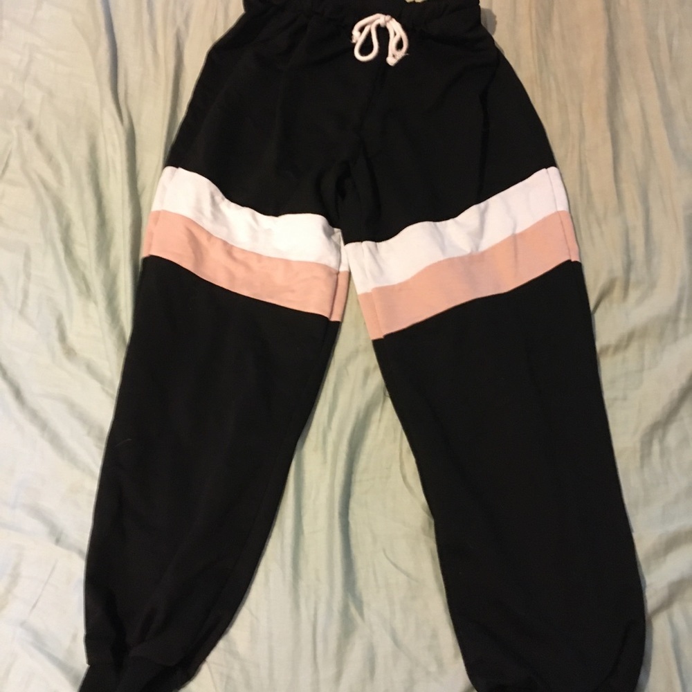 Black sweatpants with pink and white stripes